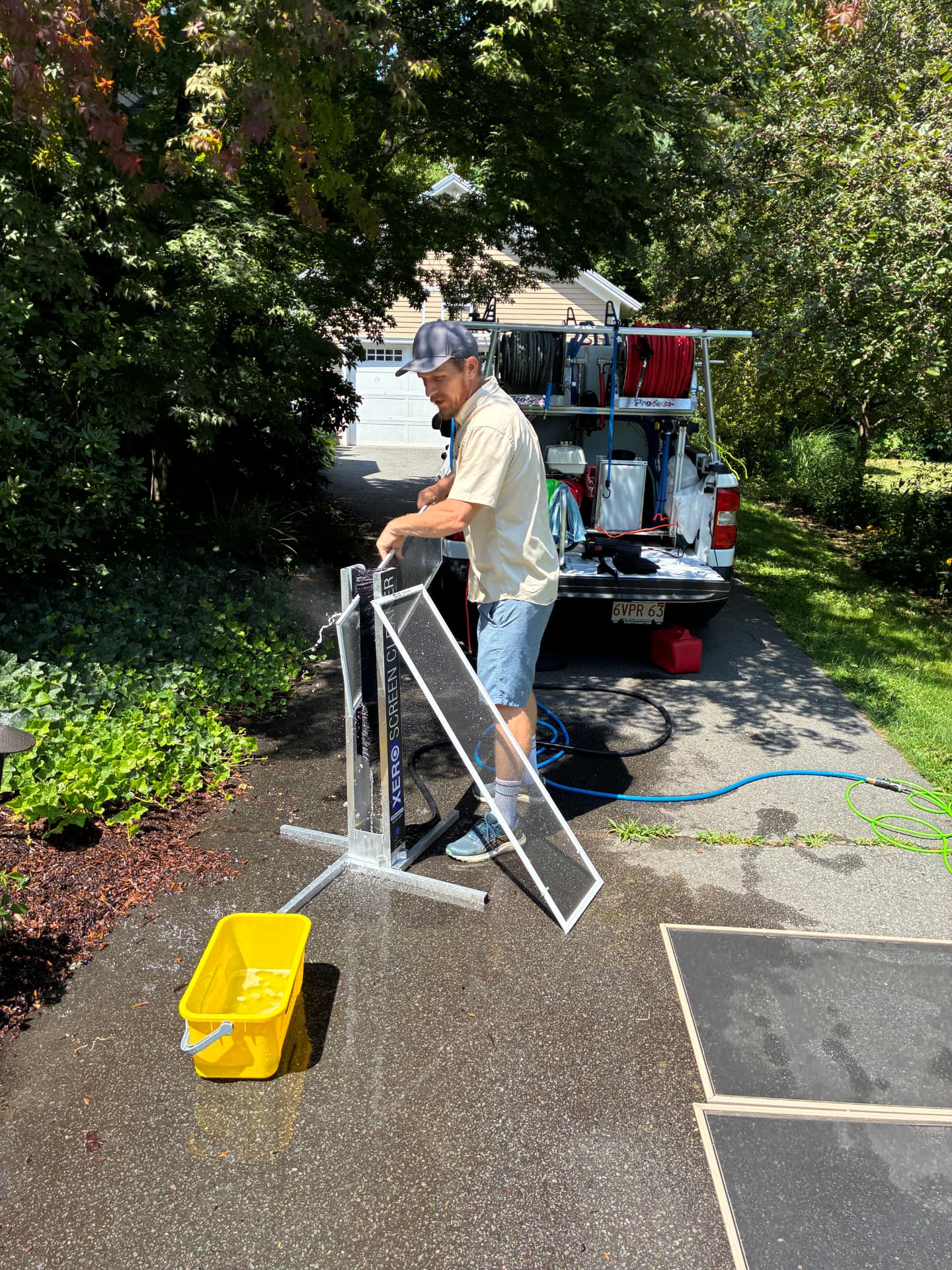 Window screens being cleaned on site